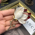 Detailed close-up of white enamel magnolia flower brooch with golden stem and crystals - C89 Brooch / White