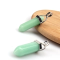 Double pointed green crystal hexagonal prism pendant with silver clasp on wooden stand - Luminous Green