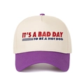 Close-up of contrast-color cap with 'It's a Bad Day to Be a Hotdog' embroidery detail - Purple