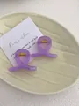 Detail of lavender translucent resin hair claws with gold metal spring on a ceramic tray - Mini Butterfly Clip X-Shaped (Approx. 4cm) / Translucent Taro Purple