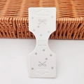 White cardboard hair clip display card with silver bow and star pattern design - Bowknot Star Card