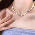 Minimalist necklace featuring irregular pearls and multicolored handmade beads worn by a model - Mini Seed Bead Necklace (X3664) / Colorful