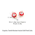 Macro shot of 11.1x7mm red and white enamel evil eye charm with dual gold connector loops - Gold-Red Evil Eye