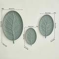 Set of three sage green leaf-shaped iron decorative trays with detailed vein textures - Gray