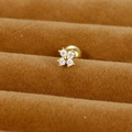 Detailed close-up of a golden four-leaf flower stud earring with sparkling cubic zirconia - Four-Petal Flower / Gold / 0.1