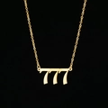 Macro shot of gold-plated stainless steel 777 number pendant on a minimalist chain - 777 Gold