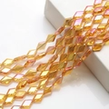 Detailed view of iridescent amber diamond-cut crystal glass beads for DIY jewelry making - Gold Rose Red