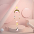 Detail showing gold sun and moon metal charms with faceted AB crystal drop pendant - US 5