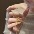 Close-up of a 24K gold plated rocking horse necklace with a Ping An charm on a fine chain - 32# Necklace Gold Ping An Plate Pony