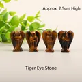 Set of four 2.5cm tiger's eye stone angel figurines with natural brown textures - Tiger's Eye
