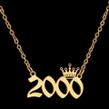 Close-up of golden crown and 2000 year number pendant necklace on black background - 2000 / Gold
