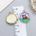 Macro view of cherry enamel charms with scale ruler showing the 2.5cm diameter size - Purple-Green Gold-Sprinkled Red Rhinestone Cherry-23569