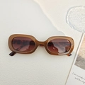 Retro oval tortoiseshell sunglasses with brown lenses on a minimalist white surface - Brown with Patterned Temples