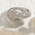 Detailed top view of snake-shaped silver ring with pave-set zircon stones on stone surface - Adjustable Open / Silver Hollow Snake