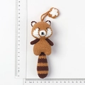 Handmade crochet red panda doll keychain with striped tail and white flower detail - Handmade Crochet Raccoon Pendant