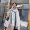 Blue and white striped knit scarf with tassels and brand tag on female model - Green and White