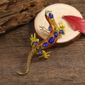 Vintage lizard brooch with orange enamel and blue crystals on a natural wood base - Orange Enamel Blue and Green Rhinestones