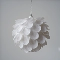 Close-up of a white petal-shaped Christmas ball with glitter texture and silver loop - Petal Style / 8cm