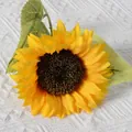Single yellow silk sunflower artificial flower with green leaves on white textured fabric - New Style Sunflower (Yellow)