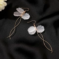 Detailed macro of long gold fringe earrings with layered translucent white petals - Long Flower Tassel (0895)