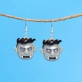 Ghost vampire face earrings hanging on rope against a vibrant blue background - Vampire / Grey (Vampire)