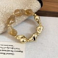 Detail of amber acrylic beads and golden metal spheres on a vintage jewelry bracelet - Bracelet / Gray