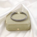 Detail of silver twisted cable cuff bracelet on a sage green jewelry display box - Steel 1