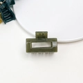 Detailed view of a dark green jelly-textured rectangular hair claw on a white plate - Jelly Mini Claw - Square Olive Green