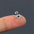 Silver evil eye stud earring with clear zircon and black center stone held on fingertip - Evil Eye / Silver (Evil Eye)