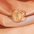 Macro shot of gold coin ring with Queen Elizabeth relief on champagne satin - Vintage Portrait/Gold Coin