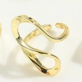 Macro shot of polished gold-tone wavy ring showing minimalist fluid metal texture - Irregular Wave Style (JZ0335) / Gold