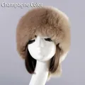 Detail view of champagne faux fur hat with thick plush texture and warm round flat top - Champagne