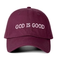 Detail of white God Is Good embroidery on a burgundy cotton baseball cap with ventilation holes - One Size / Burgundy