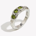 Polished silver ring with three green zircons and irregular texture at a 45-degree angle - US 6 / Silver-Green Zircon