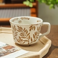 Minimalist ceramic mug with hand-painted brown leaves on a creamy white finish - Bean Leaf