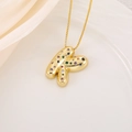 Close-up of gold bubble letter K pendant with vibrant multi-color zircon stones - Letter K