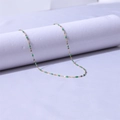 Detail of 18k gold lip chain necklace with green enamel oval beads on white display - Gold + Dark Green / 40+5cm