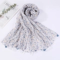Detailed view of the lightweight floral print scarf featuring delicate tassel fringe edges - Style 12