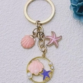 Pink starfish and seashell alloy keychain with pearls and crystals on a white background - Pink Purple Pearl Ocean Mix
