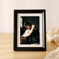 Minimalist black wood grain photo frame with cream mat board on a wooden desk - Obsidian Black Frame + Mat