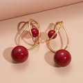 Geometric acrylic earrings with red round beads and interlaced golden metal loops - Gold-Red