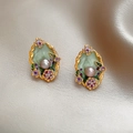Detailed close-up of retro floral enamel earrings with pearls on champagne silk fabric - Silver Pin Pearl Flower Style (Green/Purple)
