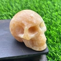 5cm hand-carved yellow calcite crystal skull figurine with natural semi-precious stone texture - Sunstone
