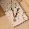 Bohemian gold necklace with colorful beads and a sun totem pendant on a sand base - Sun Totem (as)