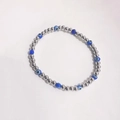 Elastic beaded bracelet with polished silver beads and blue evil eye charms on white - Blue Eye - Silver