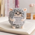 Handmade crochet positive sheep doll with motivational card on an open book - Sheep Grey