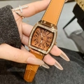 Elegant rose gold rectangular watch with diamond bezel and brown leather strap on wrist - Rose Gold Coffee
