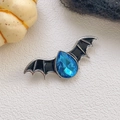 Detail of gothic bat brooch with blue crystal teardrop and black enamel for Halloween - Bat Style / Blue