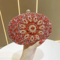 Macro detail of luxury red sunflower evening clutch with intricate crystal rhinestones - Red