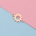 Close-up of rose gold sunflower-shaped stainless steel jewelry pendant on a bicolor background - Rose Gold